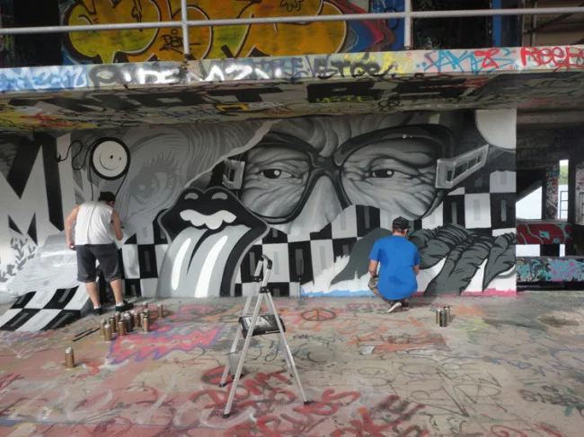 The London Police embellishing an epic mural by Tristan Eaton